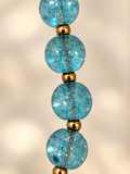 Close-up detail of blue quartz beads and gold separators