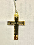 Close-up of the Bliss rosary’s dark and gold geometric crucifix