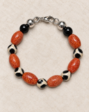 Custom-made Ebedi fire agate and black and white onyx bracelet laid flat