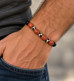 Custom-made Ebedi fire agate and black and white onyx bracelet worn on a man's wrist