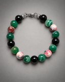 Custom-made ebedi green agate, fire onyx and black onyx bracelet on a neutral studio background