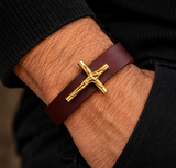 ebedi gold crucifix leather bracelet worn on a male wrist