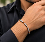 Ebedi polished silver and rose gold IP bracelet on a male wrist