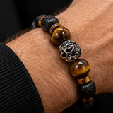 Ebedi tiger eye and lava stone skull bracelet worn on wrist