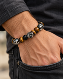 Ebedi custom tiger eye and onyx skull bracelet worn on a male wrist, original approved wrist-model image