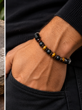 Ebedi tiger eye black onyx bracelet worn on man's wrist