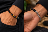 Two wrist angles showing tiger eye and black onyx beads and stainless steel double curb chain clasp