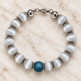 White cat’s eye bracelet with blue druzy quartz centre bead