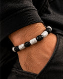 Ebedi white marble and black onyx skull bracelet worn on wrist