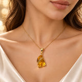 Natural citrine pendant worn on a model with a display chain; chain is not included