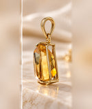 Side close-up of fancy-cut citrine and polished 10K yellow gold pendant setting