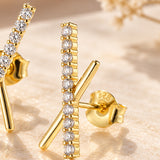 Close-up of the gold-plated crossed bars and CZ settings