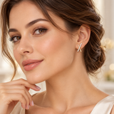 Model wearing an X-design 14K gold-plated CZ stud earring