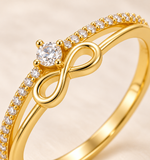 Close-up of the gold CZ infinity motif and pavé shoulder