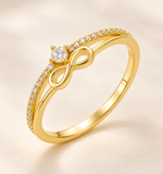 Gold-plated 925 sterling silver CZ infinity ring on an ivory background