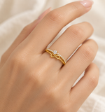 Gold-plated CZ infinity ring worn on a hand