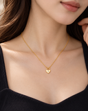 Woman wearing freya gold-plated silver heart necklace
