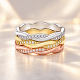Three Freya twisted rope CZ rings stacked in silver, yellow gold and rose gold