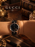 GUCCI vintage watch with black dial and Roman numerals, shown on wrist