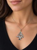 Model wearing the sterling silver Lebanese cedar tree pendant; chain shown for styling only