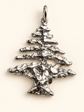 Close-up of the textured sterling silver Lebanese cedar tree pendant