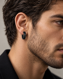 Male model in side profile wearing Moda Viking inscription hoop earring in black IP