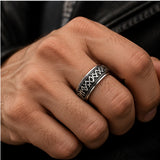 Steel Viking rune spinner ring shown worn on a hand