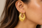Ornate gold IP stainless steel hoop earring worn on ear