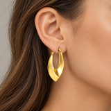 Smooth gold IP stainless steel hoop earring worn on ear