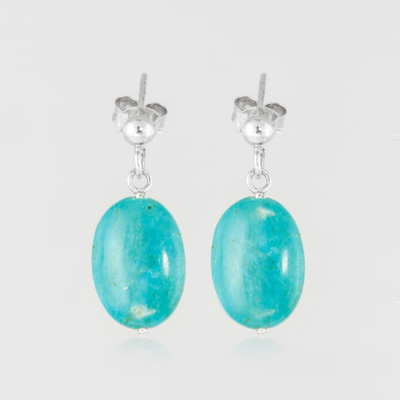 Turquoise teardrops elevate sterling silver handcrafted ﻿earring.